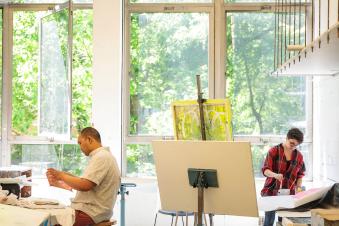 Students painting in an art studio.