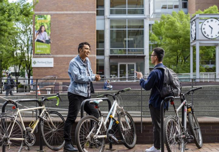 Two students talking at a bike rack