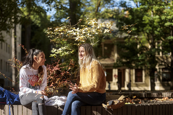 two students relaxing on campus